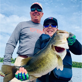 Man and Boy Holding Fish